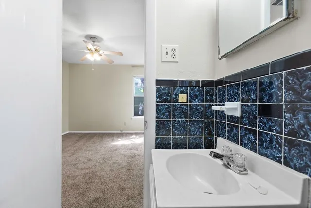 a bathroom with a sink a mirror and shower