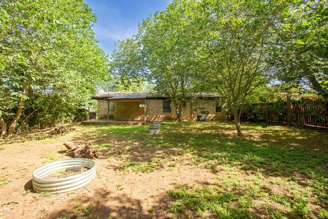 a backyard of a house with yard and outdoor seating