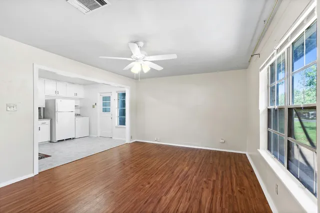 wooden floor in an empty room with a window