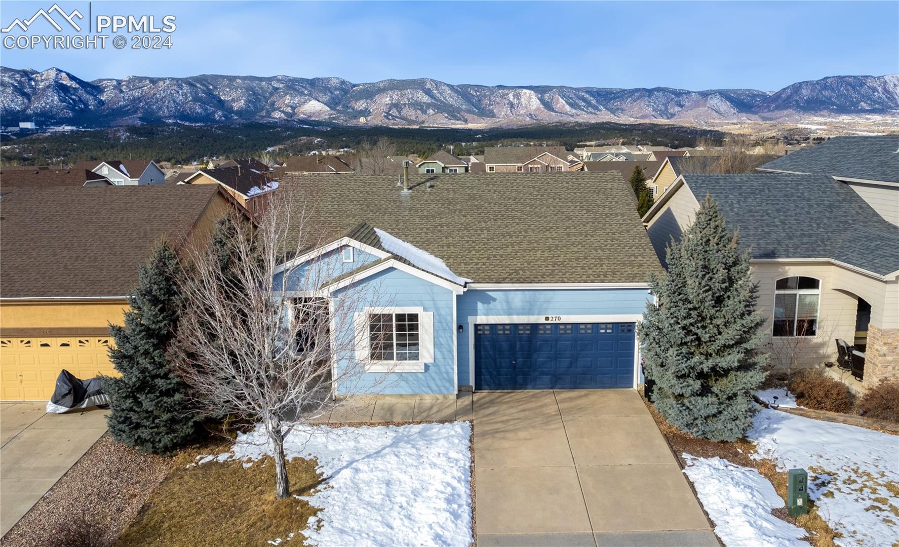 270 Avocet Loop Colorado Springs, CO 80921 - Photo 1 of 11 View of front of home with a garage and a mountain view