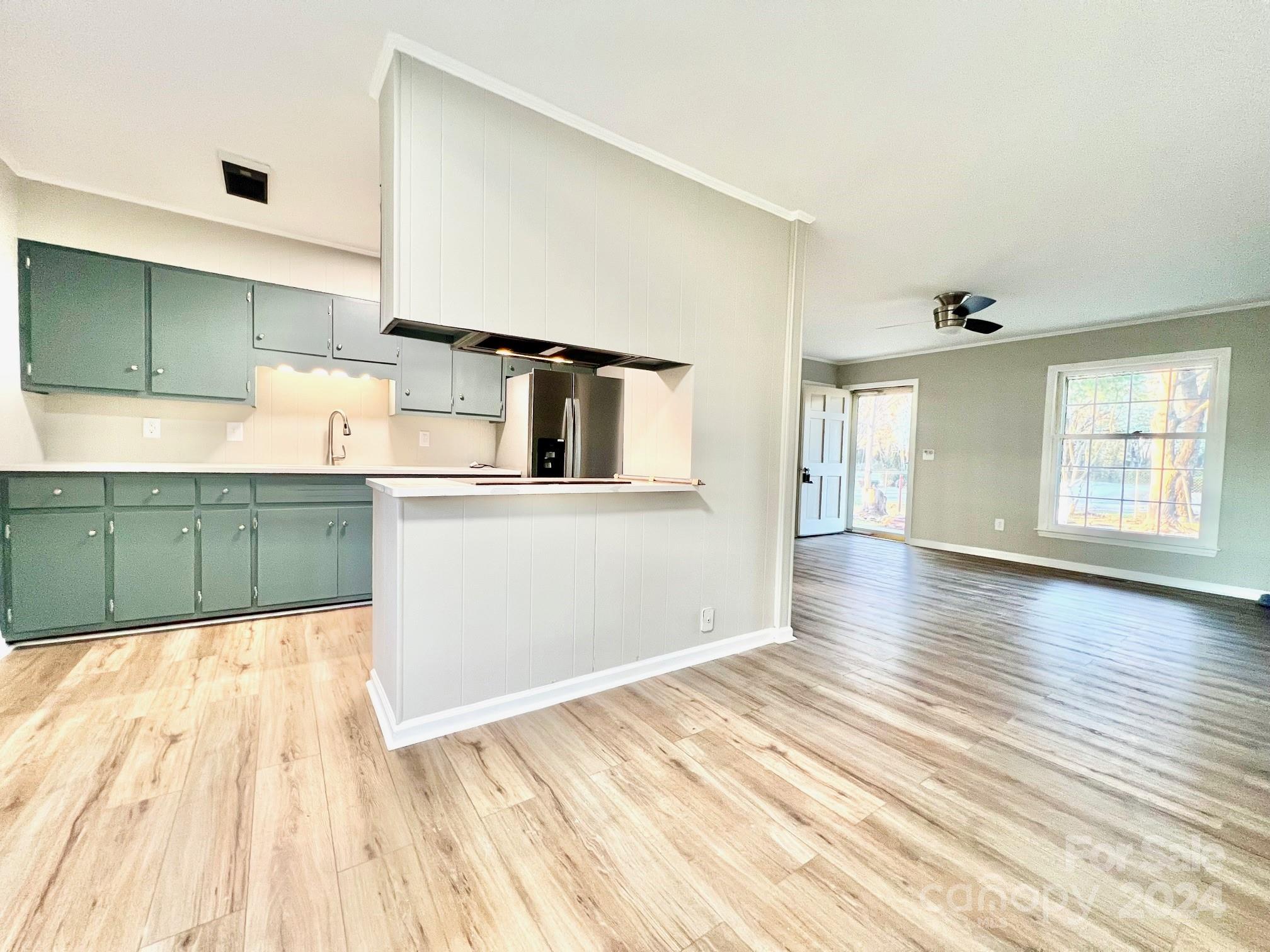 4218 Lower Cedar Valley Road Hudson, NC 28638 - Photo 7 of 27 a kitchen with granite countertop wooden cabinets and white appliances