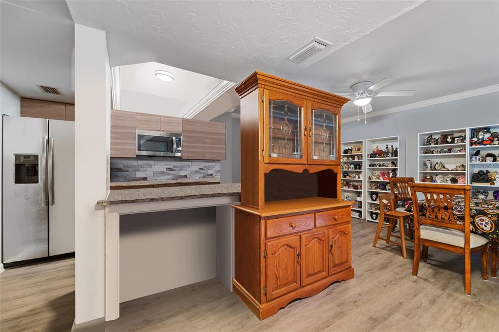 1112 Longfellow Road Sarasota, FL 34243 - Photo 11 of 48 a kitchen that has a lot of cabinets a sink and a stove in it