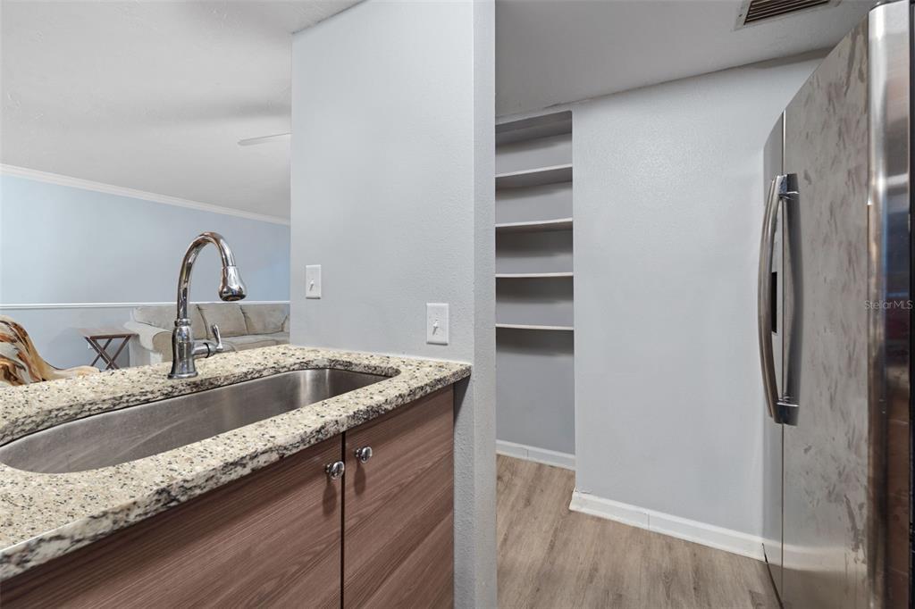 1112 Longfellow Road Sarasota, FL 34243 - Photo 12 of 48 a kitchen with granite countertop a sink and a refrigerator