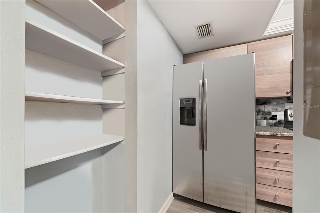 1112 Longfellow Road Sarasota, FL 34243 - Photo 15 of 48 a kitchen with stainless steel appliances a refrigerator and cabinets