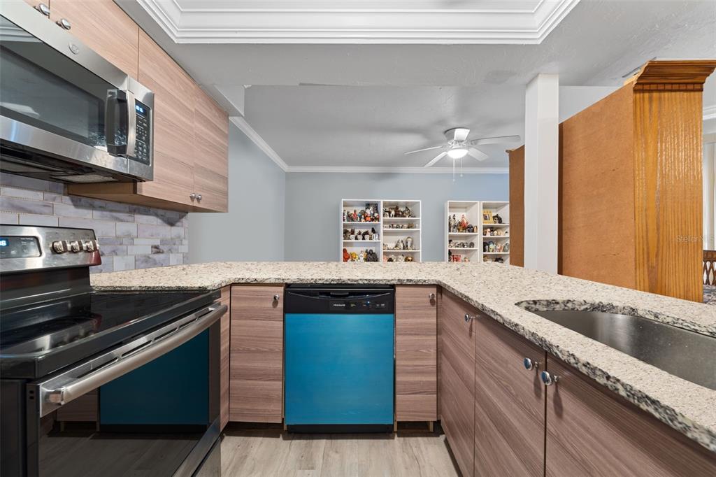 1112 Longfellow Road Sarasota, FL 34243 - Photo 16 of 48 a kitchen with stainless steel appliances granite countertop a sink and a stove