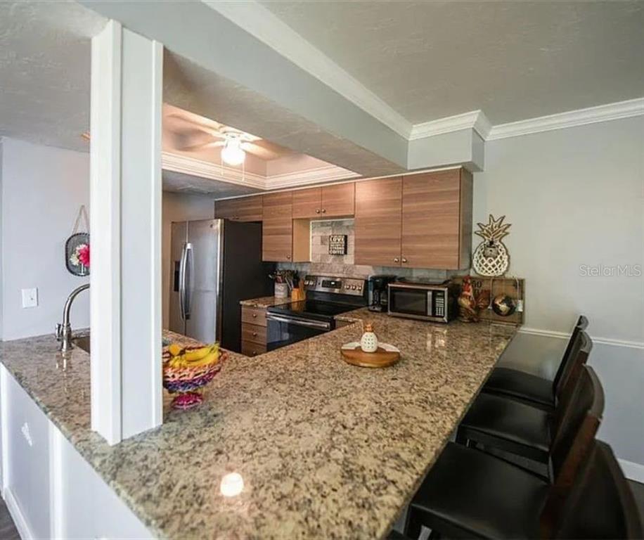 1112 Longfellow Road Sarasota, FL 34243 - Photo 17 of 48 a view of a kitchen with dining table and chandelier