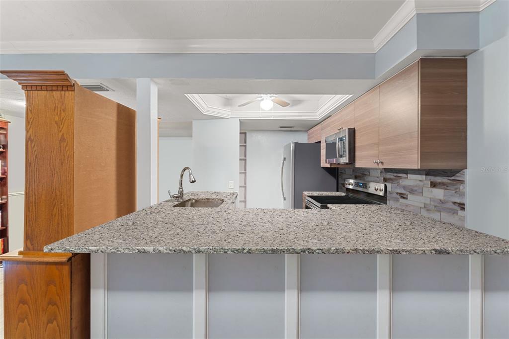 1112 Longfellow Road Sarasota, FL 34243 - Photo 19 of 48 a kitchen with stainless steel appliances granite countertop a sink a stove and refrigerator