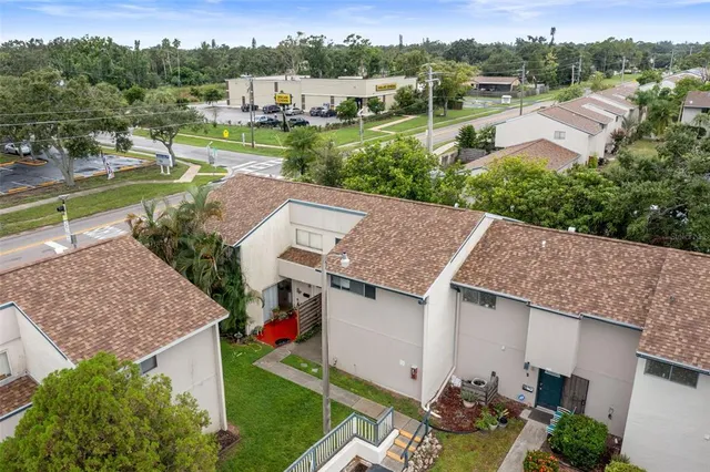 an aerial view of a house with garden space and street view