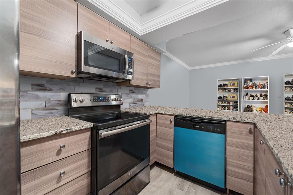 1112 Longfellow Road Sarasota, FL 34243 - Photo 3 of 48 a kitchen with stainless steel appliances granite countertop a sink stove and microwave