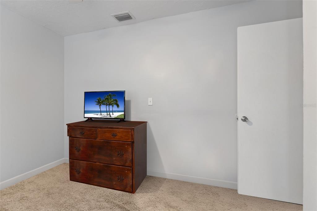 1112 Longfellow Road Sarasota, FL 34243 - Photo 33 of 48 a living room with furniture and a refrigerator
