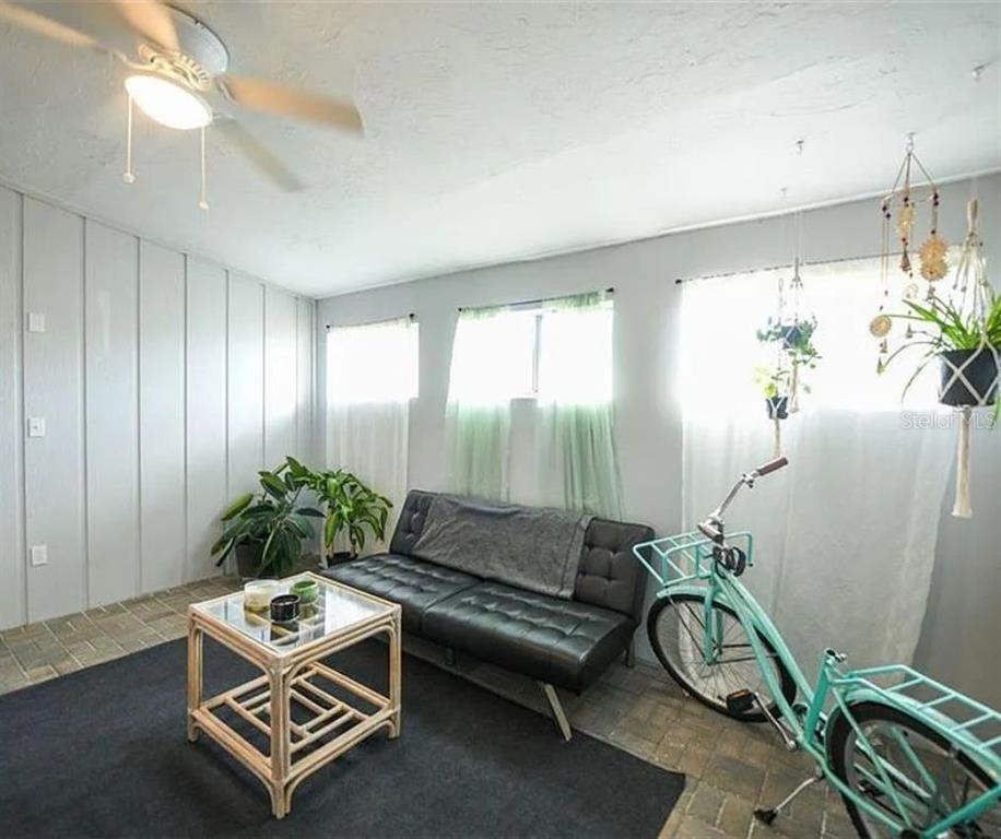 1112 Longfellow Road Sarasota, FL 34243 - Photo 42 of 48 a living room with furniture a dining table and a potted plant