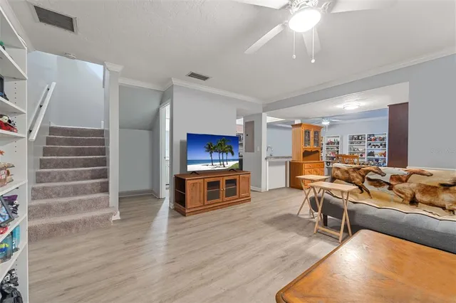 a living room with furniture and a wooden floor