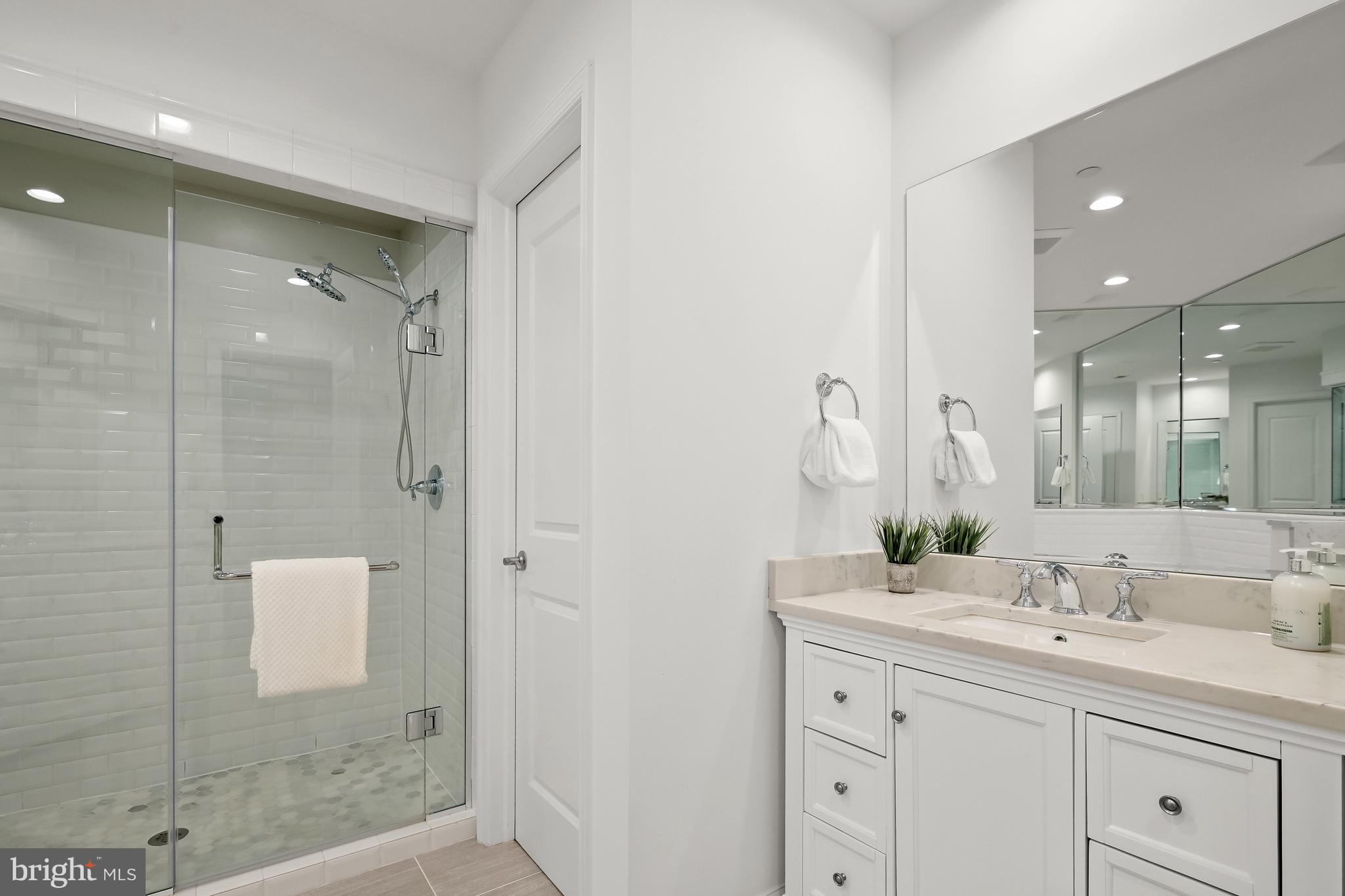 1414 22nd Street Northwest, Unit 41 Washington, DC 20037 - Photo 20 of 36 a bathroom with a shower sink and mirror