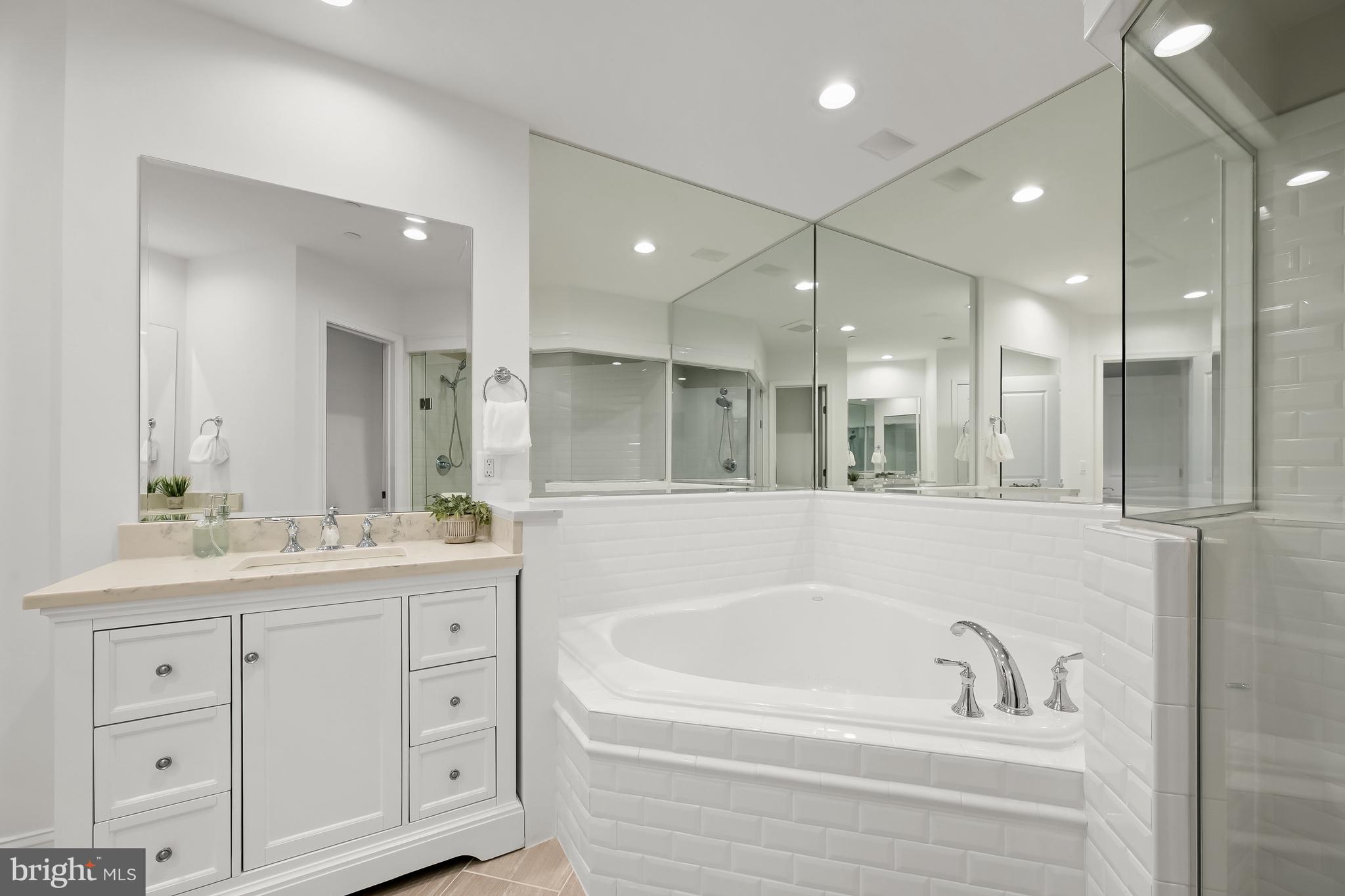 1414 22nd Street Northwest, Unit 41 Washington, DC 20037 - Photo 21 of 36 a bathroom with a bathtub a double vanity sink shower and mirror