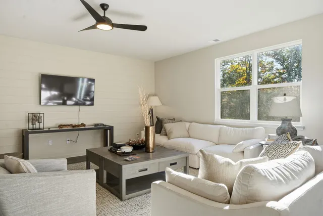 a living room with furniture and a large window
