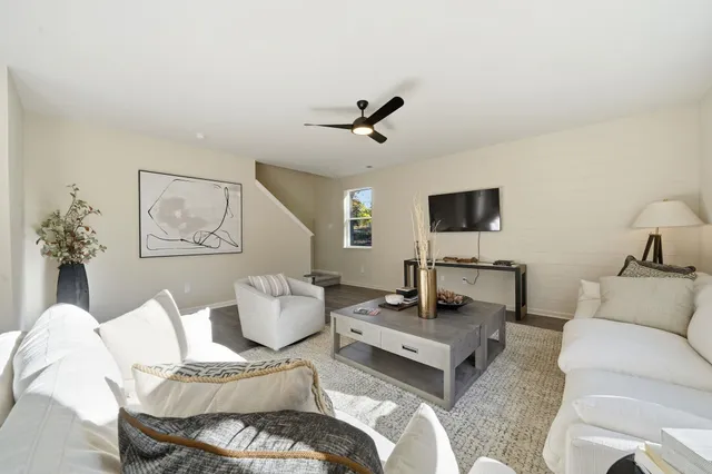 a view of a livingroom with furniture and a window