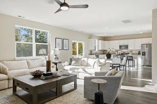 a dining room with furniture and wooden floor