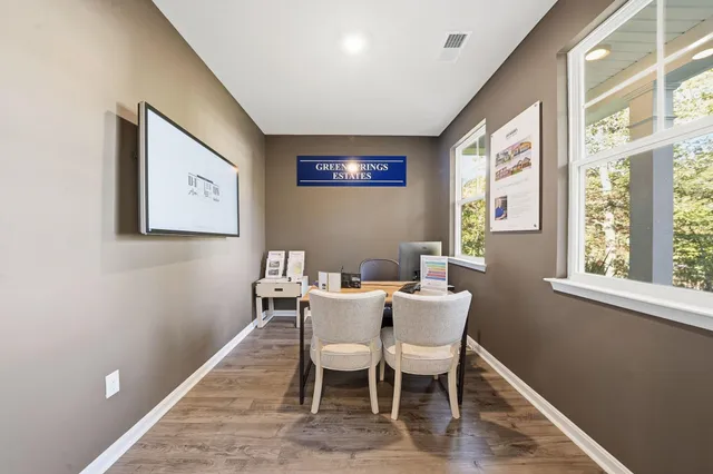a bathroom with a toilet a sink a tub and a mirror
