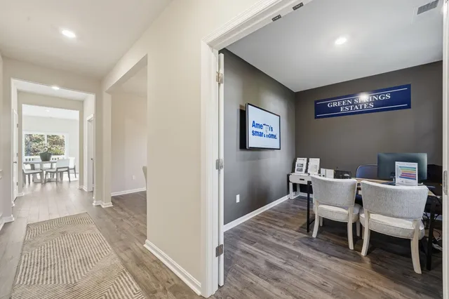 a view of living room filled with furniture and wooden floor