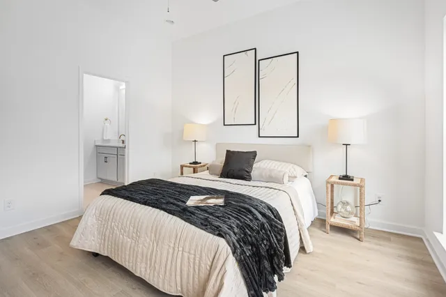 a bedroom with a bed and a lamp