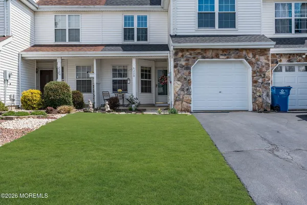 a front view of a house with a garden and porch