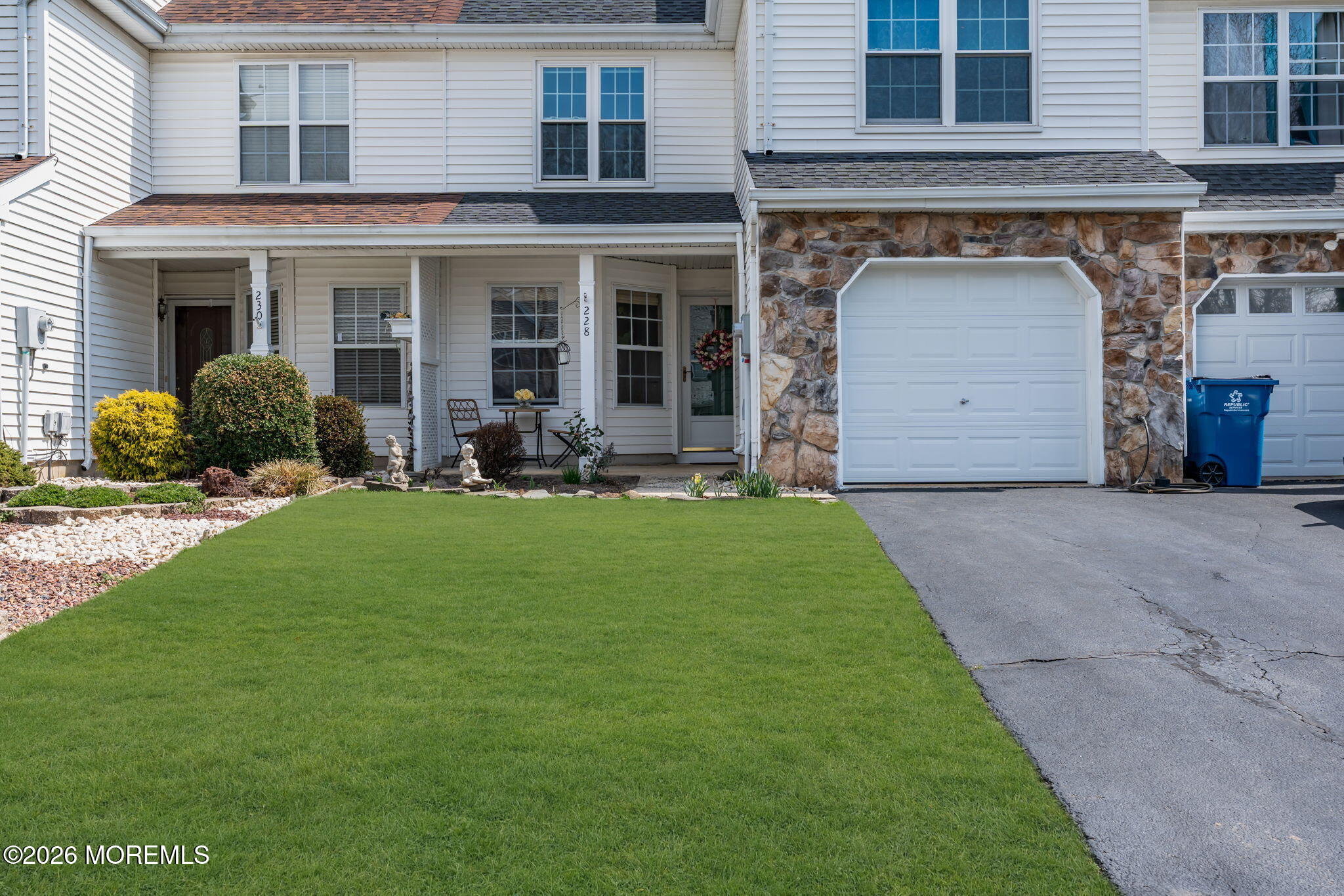 a front view of a house with a garden and porch
