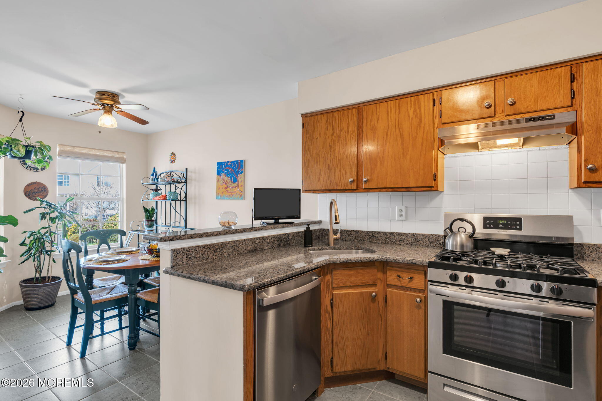 228 Moses Milch Drive Howell, NJ 07731 - Photo 12 of 26 a kitchen with stainless steel appliances granite countertop a stove a sink and a microwave