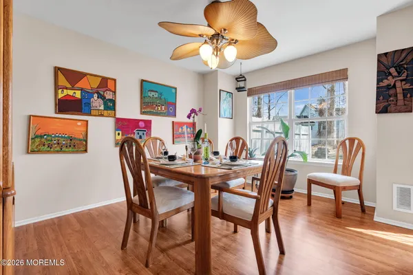 a view of a dining room with furniture window and wooden floor