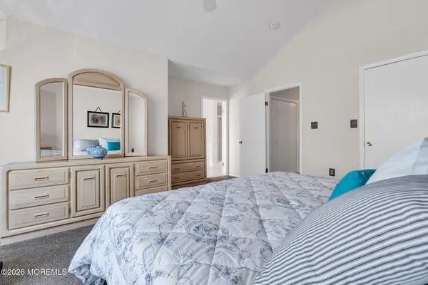a bedroom with a bed and a dresser