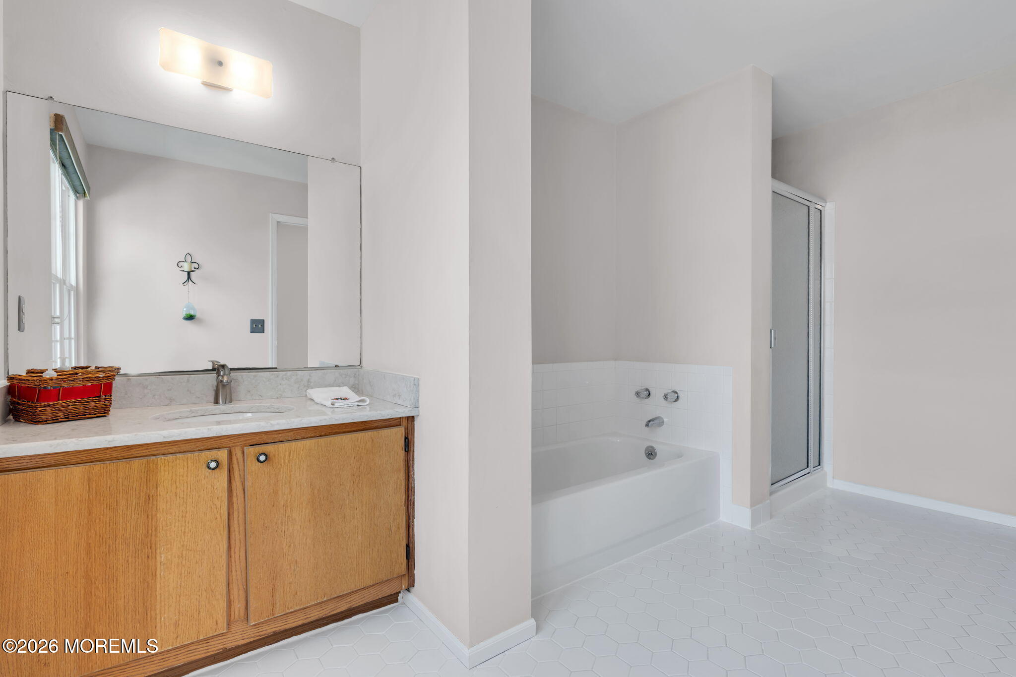 228 Moses Milch Drive Howell, NJ 07731 - Photo 17 of 26 a bathroom with a bathtub sink and mirror