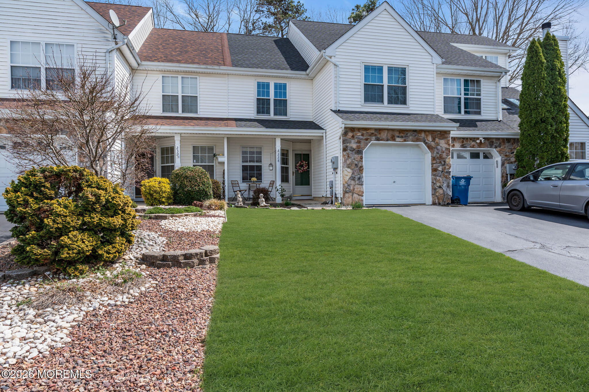 228 Moses Milch Drive Howell, NJ 07731 - Photo 2 of 26 a view of a yard in front of a brick house with large windows