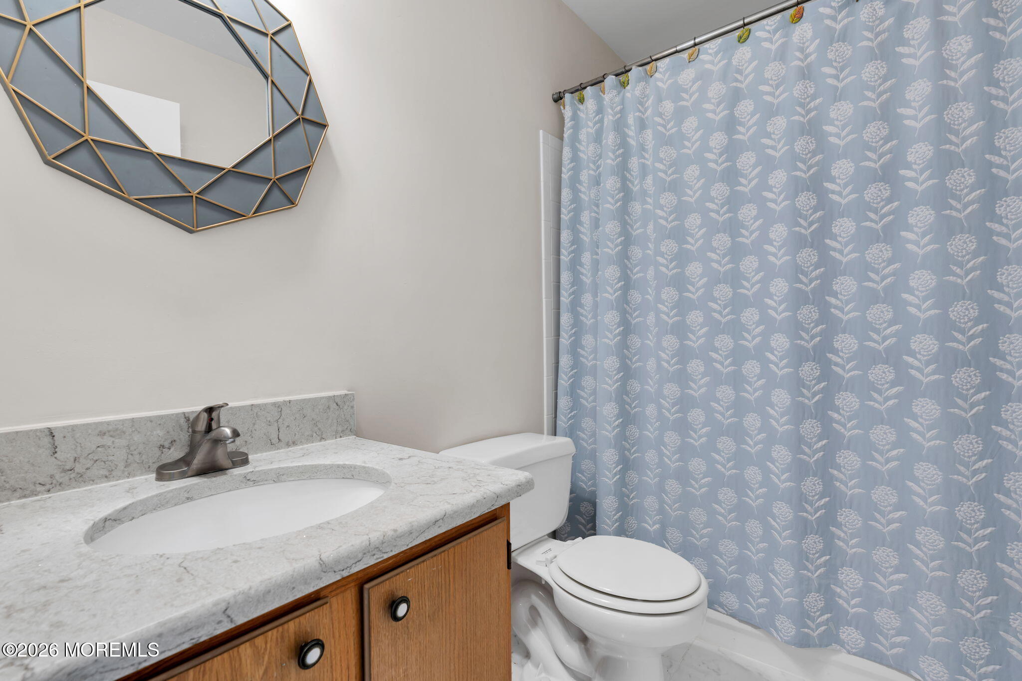 228 Moses Milch Drive Howell, NJ 07731 - Photo 21 of 26 a bathroom with a granite countertop sink and a mirror