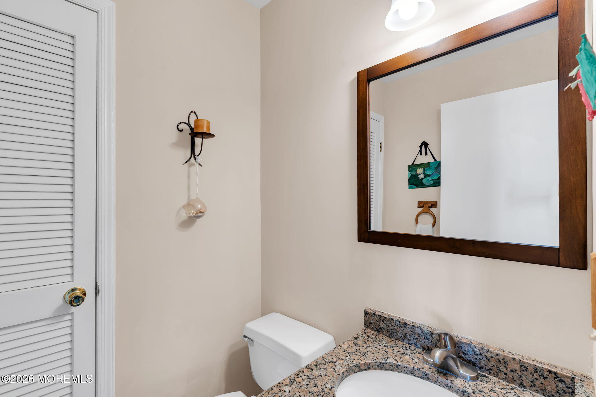 228 Moses Milch Drive Howell, NJ 07731 - Photo 22 of 26 a bathroom with a granite countertop sink and a mirror