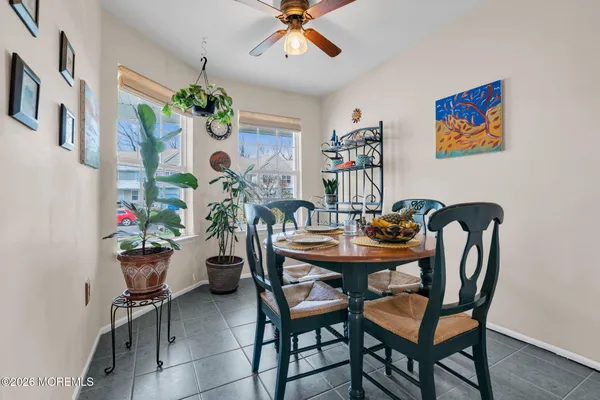 a view of a dining room with furniture and a chandelier