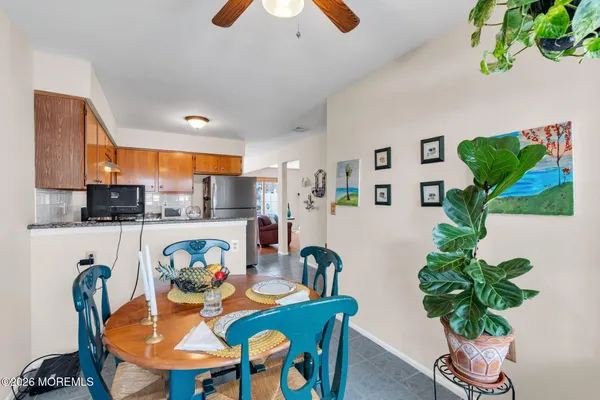 a dining room filled chandelier and kitchen view