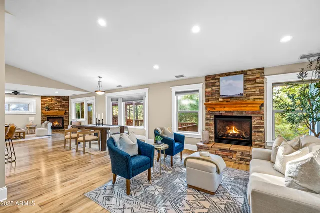 a living room with fireplace furniture and a fireplace