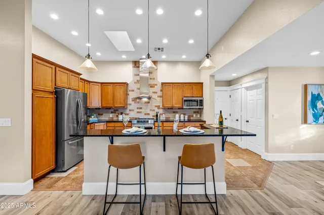 a kitchen with stainless steel appliances granite countertop counter space cabinets and furniture