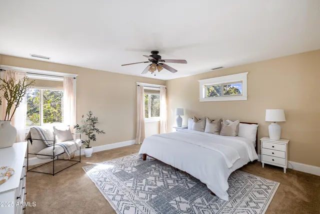 a bathroom with a tub sink double vanity and mirror
