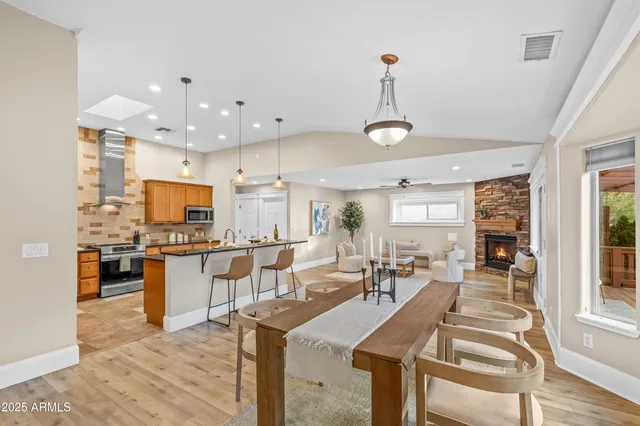 a dining room with furniture window and wooden floor