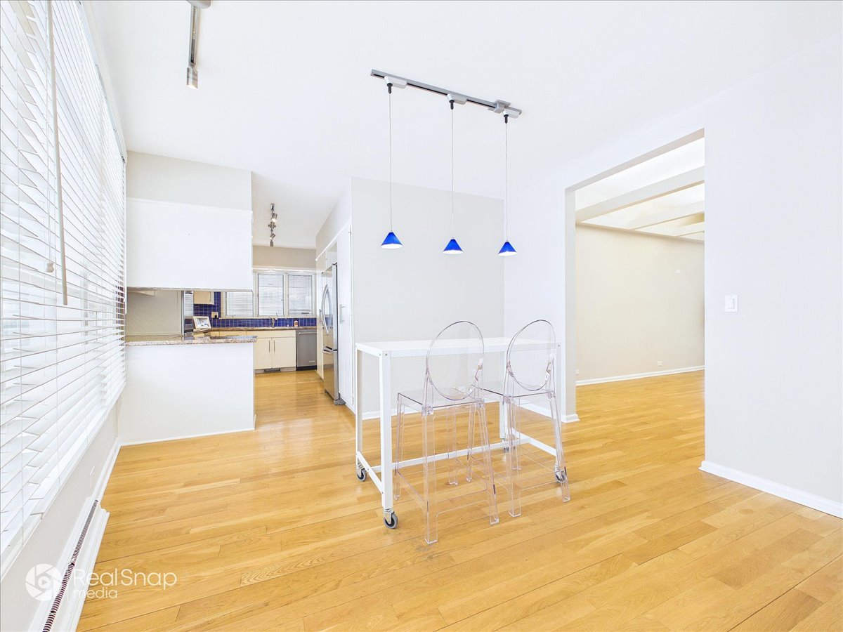 730 Sheridan Road Highland Park, IL 60035 - Photo 15 of 48 a living room with table chairs and kitchen view