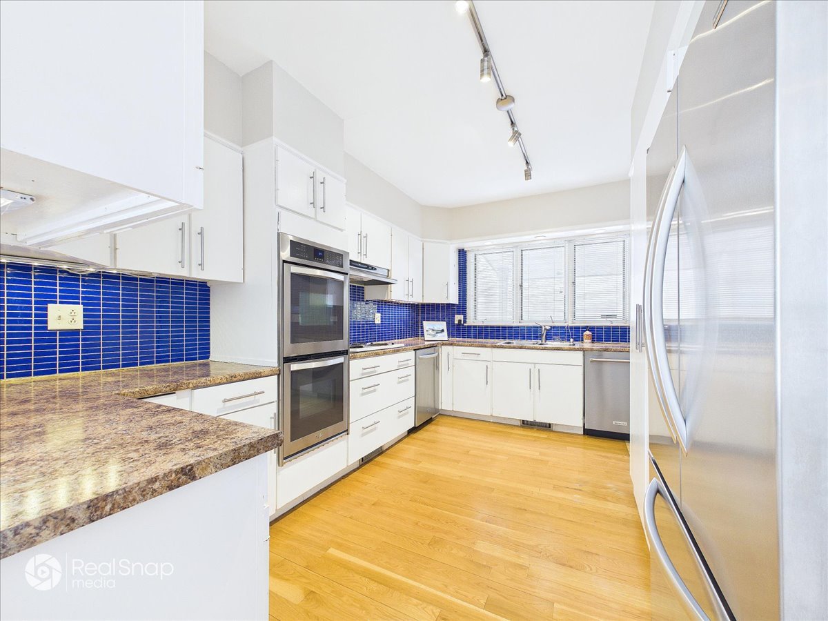 730 Sheridan Road Highland Park, IL 60035 - Photo 17 of 48 a large white kitchen with a stove a refrigerator and a sink