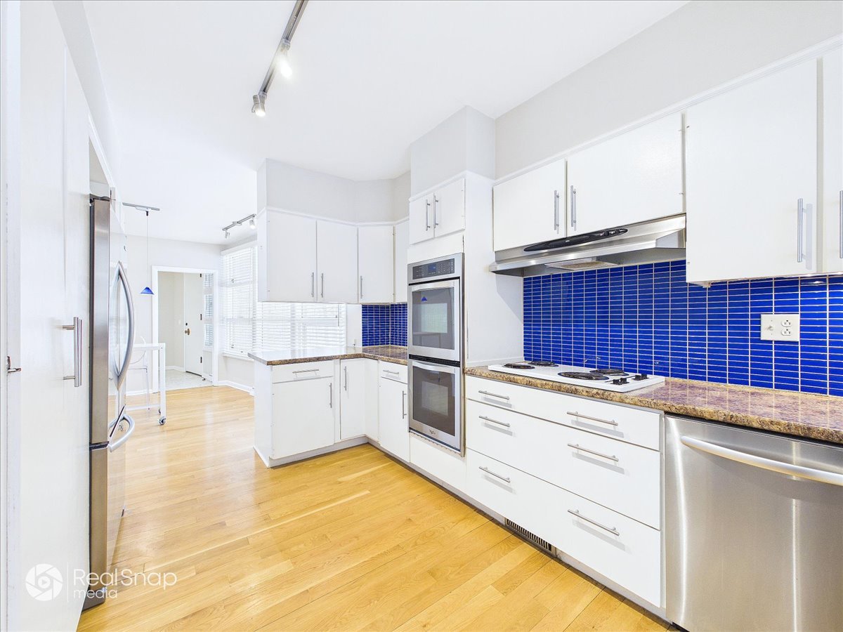 730 Sheridan Road Highland Park, IL 60035 - Photo 18 of 48 a kitchen with stainless steel appliances granite countertop a sink and cabinets