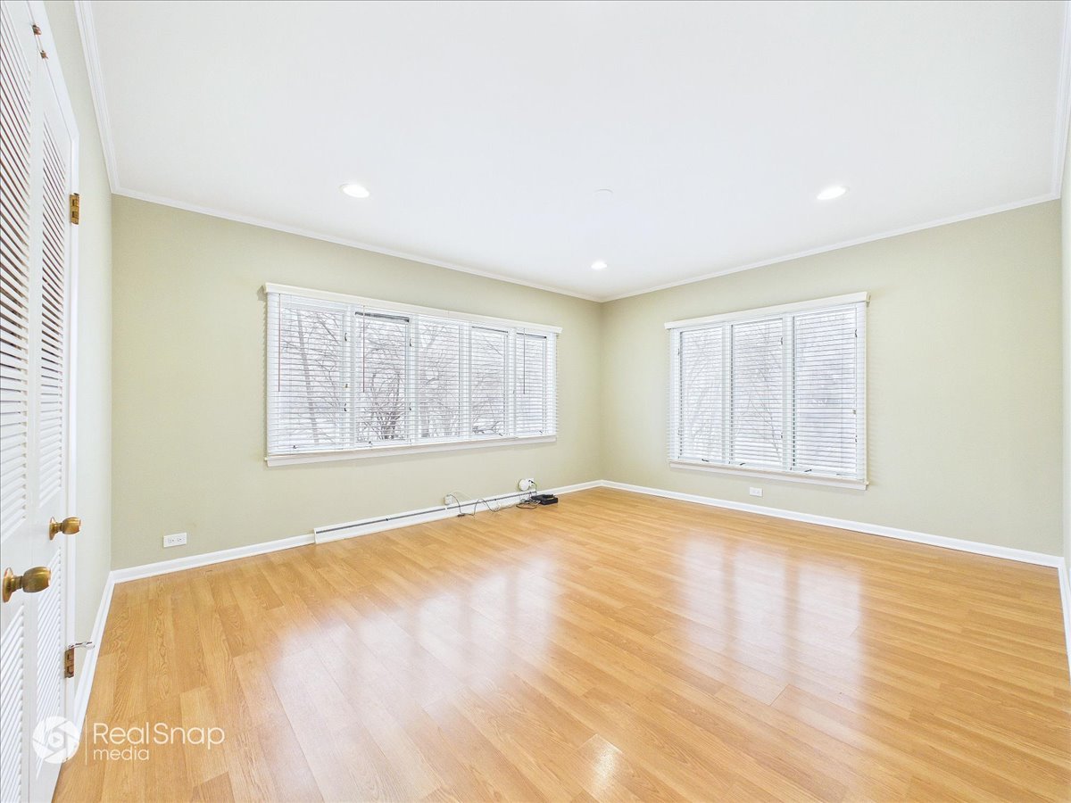 730 Sheridan Road Highland Park, IL 60035 - Photo 19 of 48 a view of an empty room with wooden floor and a window