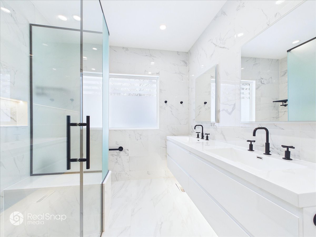730 Sheridan Road Highland Park, IL 60035 - Photo 21 of 48 a bathroom with a double vanity sink mirror and shower