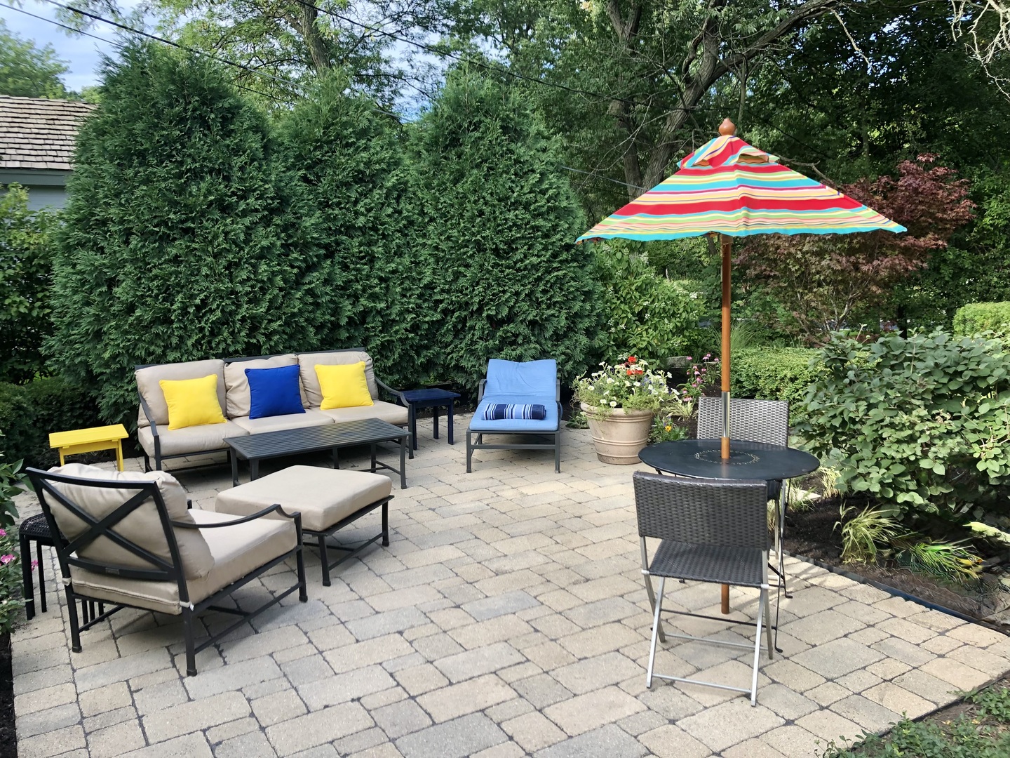 730 Sheridan Road Highland Park, IL 60035 - Photo 35 of 48 an outdoor sitting area with a couch and an umbrella