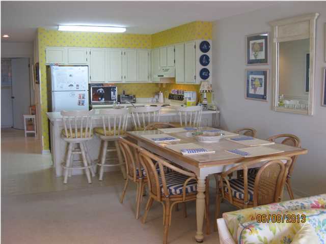 6015 Highway Santa Rosa Beach, Unit A303 30A Santa Rosa Beach, FL 32459 - Photo 2 of 12 a dinning table sitting next to a window