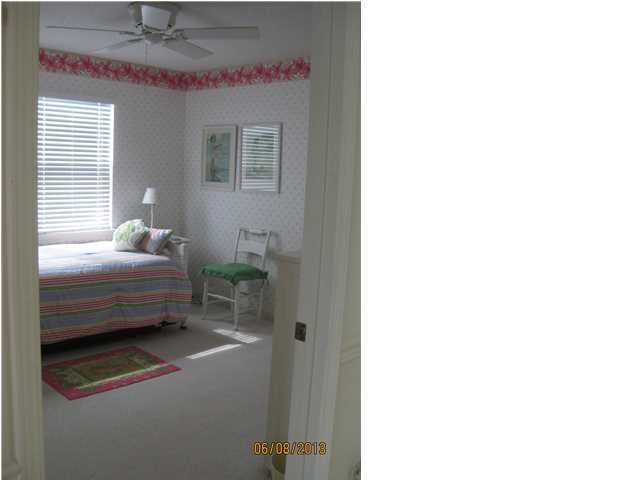 6015 Highway Santa Rosa Beach, Unit A303 30A Santa Rosa Beach, FL 32459 - Photo 7 of 12 a bedroom with a bed and a chandelier