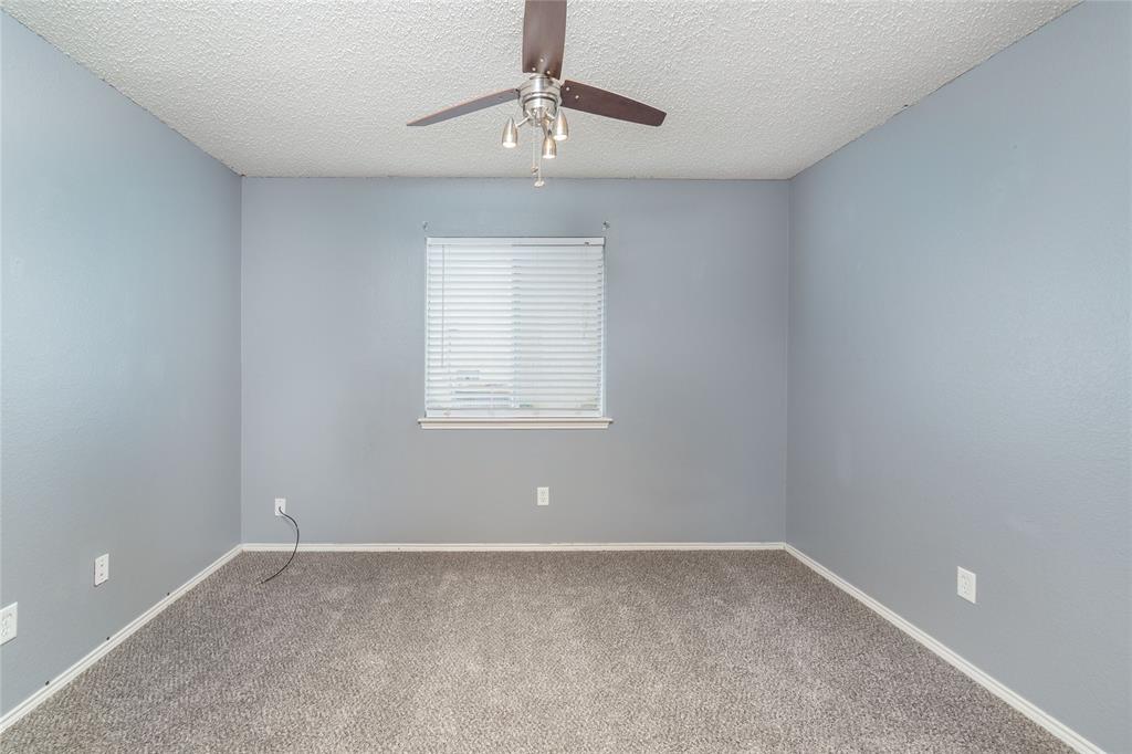 4408 Statesman Lane Fort Worth, TX 76244 - Photo 28 of 40 Spare room featuring carpet floors, a textured ceiling, and ceiling fan
