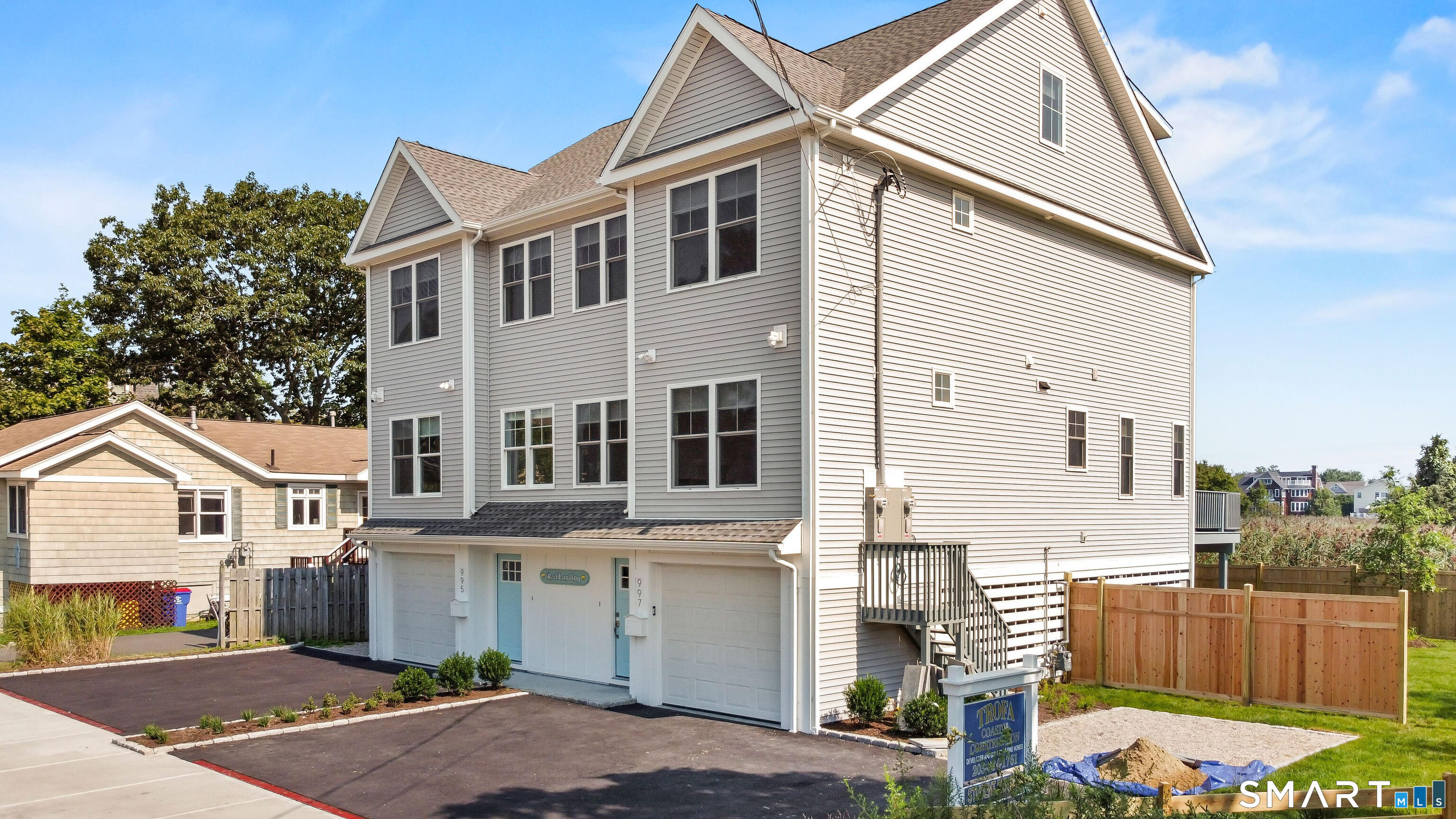 995 Reef Road Fairfield, CT 06824 - Photo 1 of 14 a front view of a house with a yard