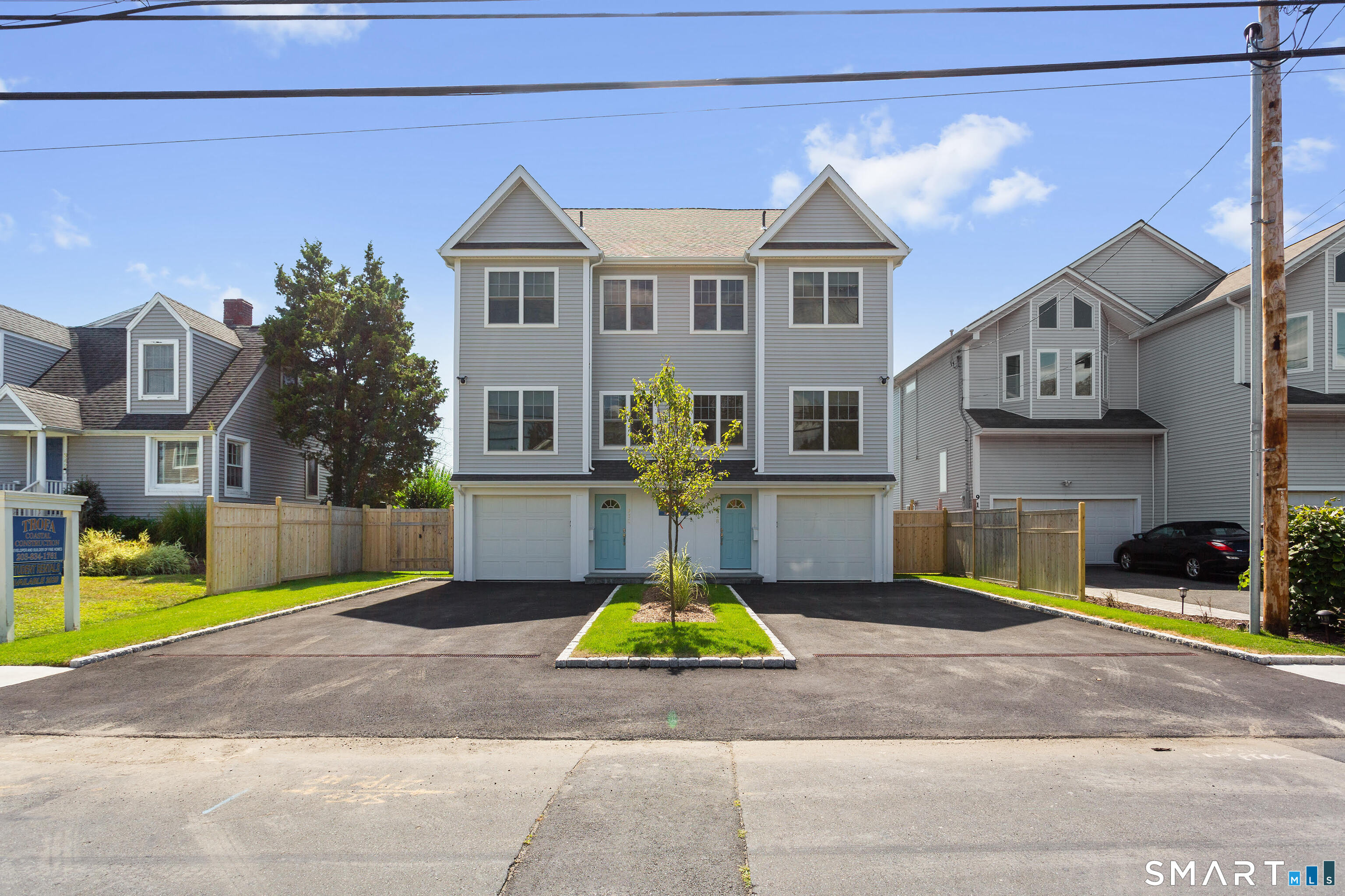995 Reef Road Fairfield, CT 06824 - Photo 11 of 14 a view of multiple houses with cars parked in front of it